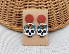 the skull earrings are decorated with flowers