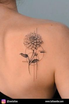 the back of a woman's shoulder with a flower and two birds on it