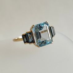 This stunning ring is set in 14k Solid Yellow Gold with Natural Sky Blue topaz and London Blue topaz with utmost precision.  It is an unique statement gemstone ring for nearly every occasion and is completely hassle-free jewelry.  ITEM DETAILS: * CENTER GEM: Sky Blue topaz * GEM SIZE: 8X10mm * GEM SHAPE: Octagon  * SIDE GEM: London Blue topaz * GEM SIZE: 5x2.5mm (2pcs) and 4x2mm (2pcs) * GEM SHAPE: Baguette * Total Gem weight: 5.25 carats * Gold Purity: 14KT (58.33% approx.) * Gold Weight: 1.55 Luxury Elegant Polished Topaz Ring, Luxury Gold Topaz Ring Timeless Style, Luxury Elegant Topaz Ring With Large Stone, Luxury Topaz Crystal Ring, Blue Topaz Baguette Cut Ring In 14k Gold, Modern Blue Topaz Ring In 14k Gold, Blue Topaz Ring With Gemstone Accents In 14k Gold, Blue Topaz Ring With Baguette Cut, Art Deco Blue Topaz Ring With Accent Stones