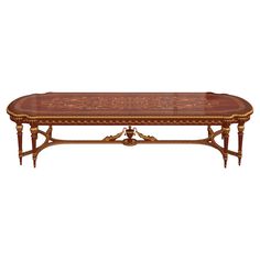 an ornately decorated coffee table with gold trimmings on the top and sides