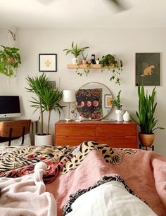 a bedroom with lots of plants on the wall