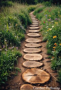 a path made out of logs in the middle of a field