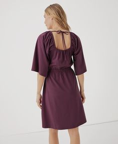 Women's Maroon Luxe Jersey Flutter Sleeve Dress 2XL. Super soft organic women's Luxe Jersey Flutter Sleeve Dress from Wear PACT. Fair Trade Factory. GOTS Certified Made With Organic Cotton Mini Length Tie Back Dress For Fall, Tie Back Mini Dress For Fall, Daywear Tie-back Dresses, Knee-length Dress With Smocked Back For Day Out, Fall Mini Length Dresses With Tie Back, Flowy Dress With Smocked Back For Date Night, Casual Dress With Ruffle Sleeves, Chic Flutter Sleeve Mini Dress For Brunch, Spring Dresses With Gathered Flutter Sleeves