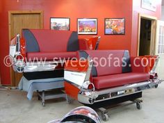 the interior of a barber shop with red and black leather chairs, pictures on the wall