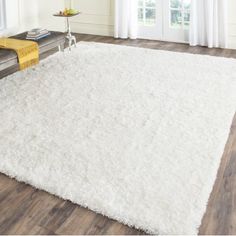 a large white rug in the middle of a living room