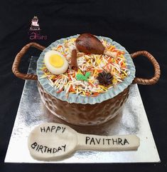 a birthday cake that is shaped like a pavthra with an egg on top