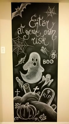 a chalkboard drawing of a ghost with words written on it and pumpkins in the background