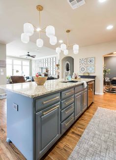 a large kitchen with an island in the middle and lots of counter space on one side