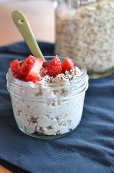 a jar filled with oatmeal and strawberries on top of a table