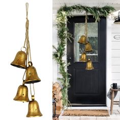 three brass bells hanging from the side of a door next to a christmas wreath and tree