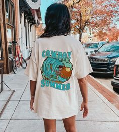 Beach Surf Skeleton Cowboy Shirt is an oversized preppy t-shirt with a coastal cowgirl meets retro western design, perfect for the VSCO coconut girl teen aesthetic. This beach tee is the ideal addition to any summer wardrobe, perfect for riding the waves or lounging on the sand:) **USUALLY SHIPS WITHIN 1-4 DAYS** ABOUT PRODUCT: -Comfort Colors Shirt -The tee is a dyed, soft-washed fabric. -The loose shape makes it a great daily wear.  -The garment has no side seams and the double-needle stitchin Trendy Long Sleeve T-shirt For Beach, Oversized Casual T-shirt For Beach Season, Oversized White Vsco Style Tops, Oversized White Vsco Top, Oversized Screen Print T-shirt For Day Out, Casual Long Sleeve T-shirt For Vacation, Oversized Tops For Beach Season Streetwear, Long Sleeve Graphic T-shirt For Vacation, Long Sleeve Graphic Print T-shirt For Vacation