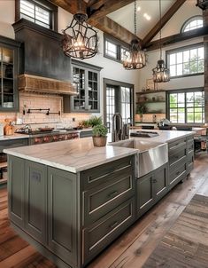 a large kitchen with an island in the middle and lots of windows on both sides