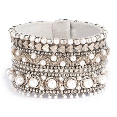 Complete your outfit with the stunning Orion Bracelet, adorned with hand-embellished pearls and a touch of metallic shine. This statement bracelet adds a touch of elegance and sophistication to any look. Show off your unique style with the Orion Bracelet. Hand embellished statement bracelet. Cotton woven Glass beads Metallic thread Pearl Suede backing Brass Magnet closure Size: Length 1.5" | Width 7" Please note: Due to the handmade nature of our collection, colors and patterns may vary slightly Chic Silver Bracelets For Wedding, Adjustable Bohemian Pearl Bracelet For Party, Elegant Silver Beaded Bangle Bracelets, Elegant Silver Bangle Beaded Bracelets, Silver Beaded Metal Pearl Bracelet, Elegant Silver Beaded Bracelets With Strap, Bohemian Pearl Bracelet For Parties, Luxury Silver Pearl Bracelet, Silver Beaded Bracelets With Strap For Party