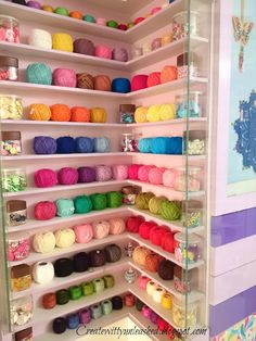 the shelves are filled with balls of yarn