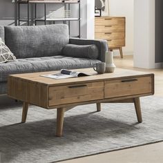 a living room with a gray couch and wooden coffee table in front of the couch