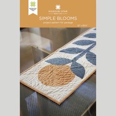 a table runner with an orange and blue flower design on the front, along with text that reads simple blooms project pattern for embroidery