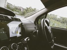 the interior of a car with an electronic display on the dash board and steering wheel