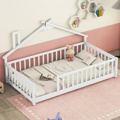 a baby crib in the corner of a room with pink walls and flooring