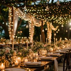 a long table is set with candles and flowers on it for an elegant dinner party