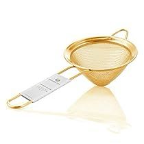 a gold strainer with a price tag on it