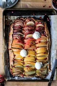 an apple and raspberry tart with whipped cream on top is ready to be eaten