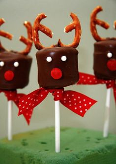 three chocolate reindeer lollipops on top of each other with bows and noses