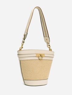 The timeless, trend-setting design of the Unlocked Bucket Bag is simply a must-have. This bag was crafted with full-grain smooth calfskin. Wear it by its adjustable, removable shoulder strap or elegantly draped over your shoulder with an alternative woven strap. With a spacious interior, it is a wardrobe staple for your everyday adventure. - Full-grain smooth calfskin leather from USA - Matching color leather interior - One internal slip pocket - One adjustable leather shoulder strap and one wov Chic Bucket Bags With Gold-tone Hardware, Chic Bucket Satchel With Gold-tone Hardware, Chic Satchel With Gold-tone Hardware Bucket Shape, Cream Bucket Bag With Adjustable Strap, Cream Bucket Bag With Detachable Strap, Cream Bucket Satchel With Detachable Strap, Versatile Cream Bucket Bag With Adjustable Strap, Chic Hobo Bag With Gold-tone Hardware, Luxury Beige Straw Bag With Gold-tone Hardware