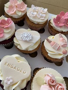 a box filled with lots of cupcakes covered in frosting and decorated like hearts