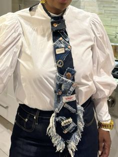 a woman wearing a white shirt and blue jean tie