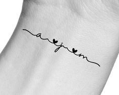 a small tattoo on the wrist that says, i love you in cursive writing