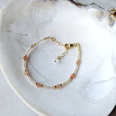 The perfect sun-kissed combination of semi-transparent extra light peach glass beads and Sunstone. This bracelet is neutral, yet warm and inviting. It is the perfect trending color and is inspired by the warm coral colors of the coast. SHOP THE MATCHING NECKLACE! Sunstone is associated with the Sun's radiant energy. This is a stone that enhances your personal power and instills your life with joy, courage and optimism. This is a stone that you want close to you at all times. Colors: This beaded Coral Colors, Light Peach Color, Oregon Sunstone, Radiant Energy, Gold Alloys, Personal Power, Light Peach, Peach Color, Gold Accent