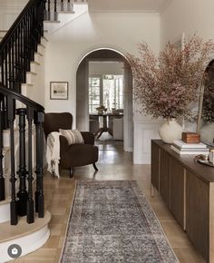 a living room filled with furniture and a large rug