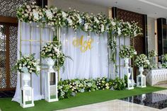 an outdoor wedding setup with white flowers and greenery