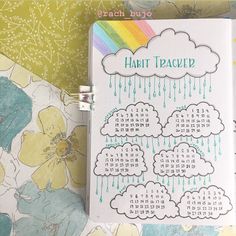 a calendar with rain coming out of it on top of a flowered wallpaper