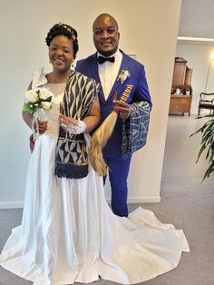 a man and woman in wedding attire standing next to each other with long blonde hair