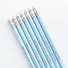 four blue pencils sitting next to each other