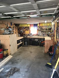 a garage filled with lots of tools and other things on the walls, including shelves