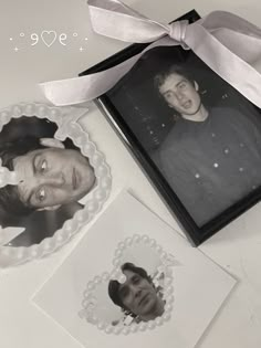 two pictures are placed next to each other with a ribbon around them and an ornament in the shape of a heart