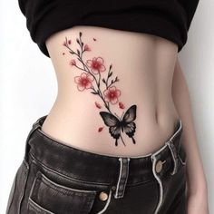 a woman's stomach with a butterfly tattoo on her side and flowers in the middle