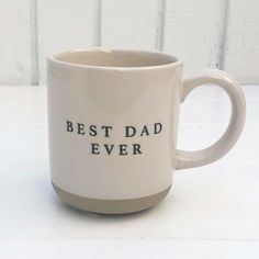 a white coffee mug with the words best dad ever printed on it, sitting on a table