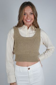 Experience effortless style with the Guinevere Layered Sweater. This unique piece features a cropped sweater vest layered over a cropped pin stripe long sleeve collared shirt for a chic and trendy look. Take your wardrobe to the next level with this fashion-forward statement piece! Size + Fit Anna is 6'1" and wearing a size Small Content + Care 100% Wool Contrast: 100% Cotton Dry Clean Only Fitted Cropped Sweater Vest, Trendy Cropped Sweater Vest For Fall, Trendy Cropped Fitted Sweater Vest, Trendy Fitted Cropped Sweater Vest, Chic Cropped Sweater Vest For Fall, Fall Layering Cropped Crop Top, Trendy Cropped Sweater Vest For Spring, Casual Cropped Vest For Work, Casual Cropped Sweater Vest For Winter