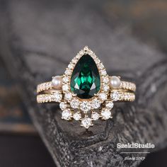 a green and white ring sitting on top of a rock