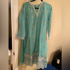 Cotton Silk Shirt With Semi Formal Embroidery. Pants, Kurta, And Dupatta. Size 12/Medium Bust Is 22 Inches Blue Long Sleeve Kurta With Gota Work, Spring Salwar Kameez With Gota Work And Long Sleeves, Spring Long Sleeve Salwar Kameez With Gota Work, Bollywood Style Kurta With Gota Work For Spring, Traditional Green Pant Set With Resham Embroidery, Spring Semi-stitched Salwar Kameez With Gota Work, Semi-stitched Salwar Kameez With Gota Work For Spring, Blue Sharara With Chikankari Embroidery For Spring, Spring Blue Sharara With Chikankari Embroidery