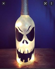 a lighted bottle with a skull face on it