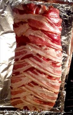 bacon wrapped in aluminum foil sitting on top of an oven