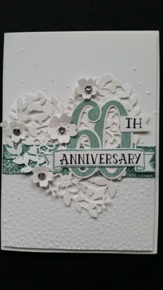 an anniversary card with flowers and the number sixtyth anniversary written in white on it