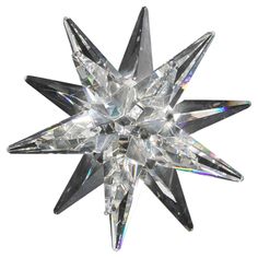 a crystal star ornament on a white background