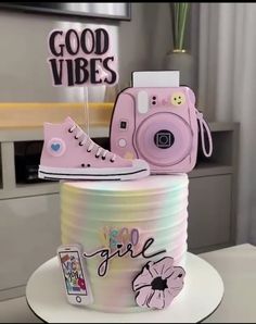 there is a cake that has a camera on it and some decorations in the shape of shoes