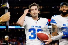 two detroit lions football players standing next to each other