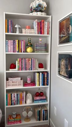 a white book shelf filled with lots of books